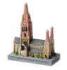 a small resin model of St Paul's cathedral, melbourne, Australia. 7cm by 5cm painted grey and light brown with one tall central spire and 2 smaller spires