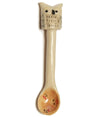 a small pale coloured ceramic spoon with a coloured bowl and a small owl on the end of the handle