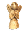 a simple carved wooden angel, kneeling with praying hands. a large head and without facial features